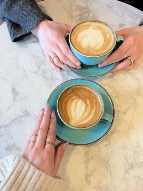 Two cups of coffee at Tiara Kaffebrenneri in light blue crockery.