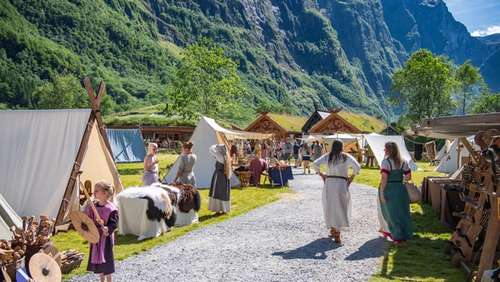 People dressed in old fashion viking clothes in a viking village.