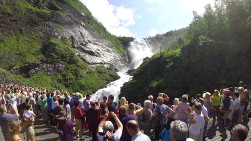 People looking at a large waterfall.