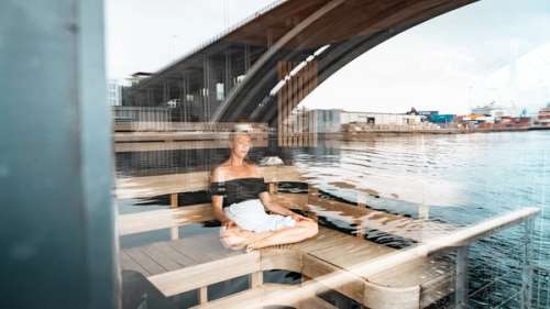 Woman sitting in a sauna.
