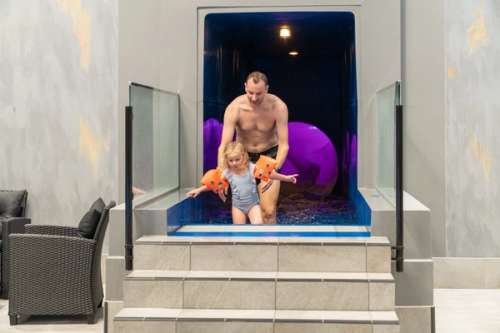 Father and daughter in a small pool.