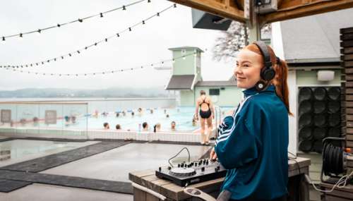 DJ playing at an outdoor pool.