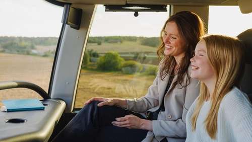 Mother and daughter sitting on the upper deck at the front of the bus