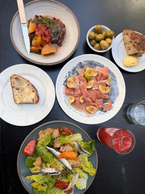 Table filled with delicious sharing dishes in all colours.