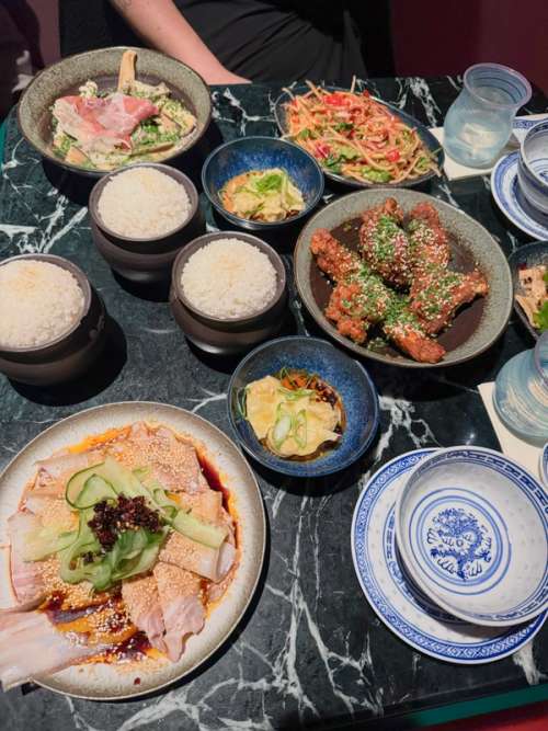 Dishes placed at a marble like table.