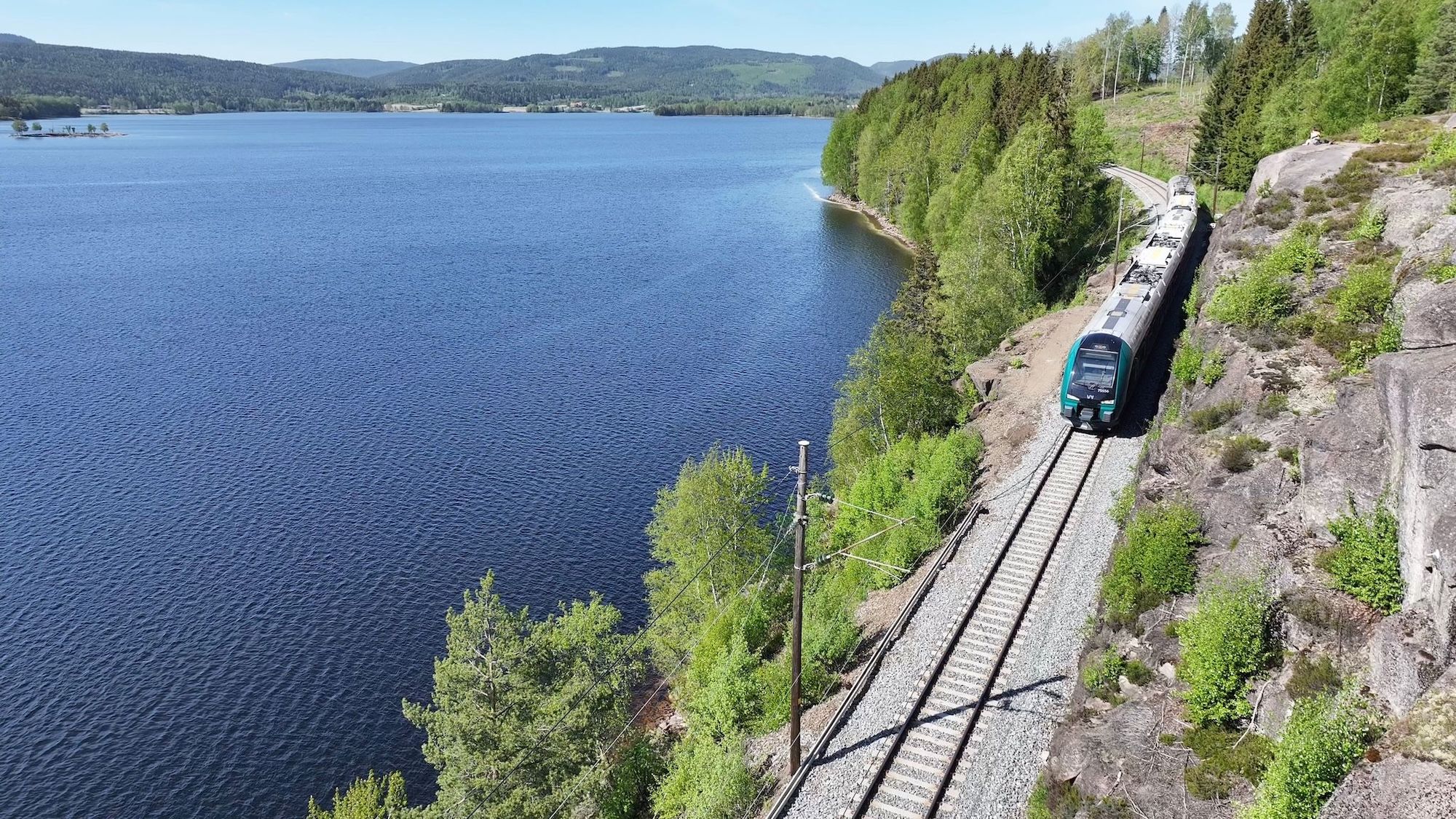 Tog kjører gjennom vinterlandskap på Gjøvikbanen