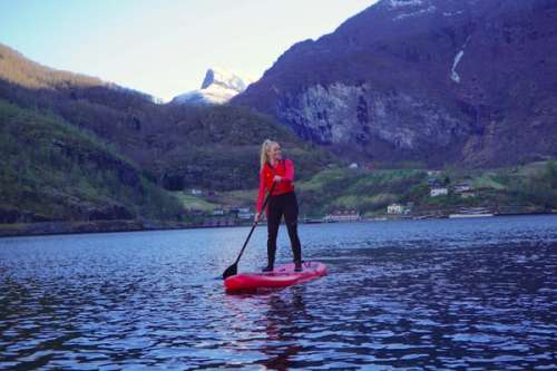 Woman on a paddle board on the fjord in Flåm