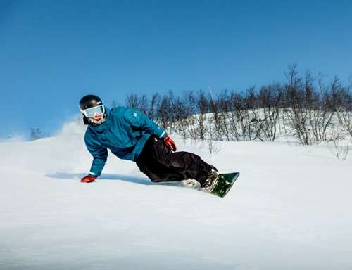 Person snowboarding down the ski slope.