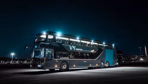 A Vy bus parked in the night.