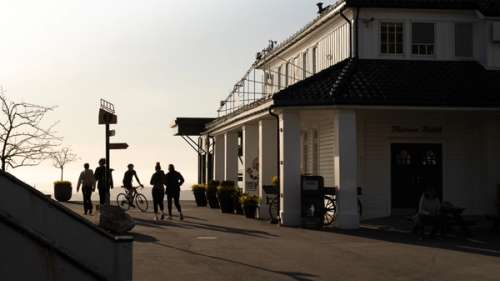 Building with people jogging past.