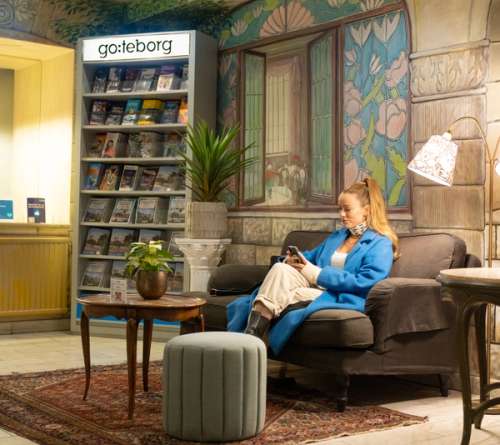 Woman sits at the reception desk in a hotel.