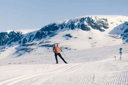 Person cross-country skiing in spectacular mountain landscape.