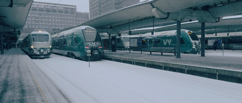 Ice and snow on trains at a station.