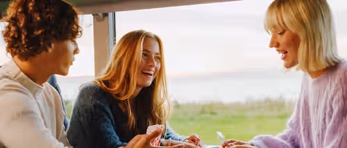 3 people sitting together on the train.