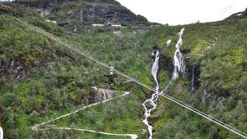 People ziplining over a forest.