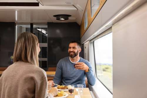 Couple eating dinner in the kafe on the train.
