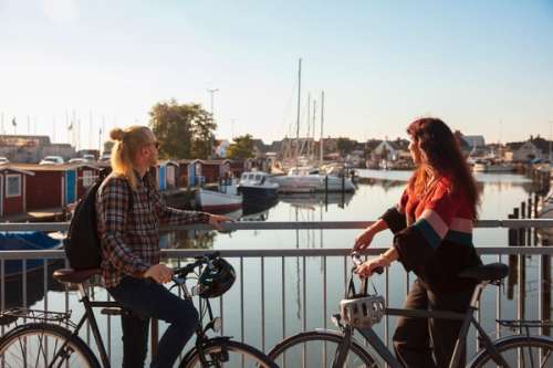 Two people on bicycles on a bridge