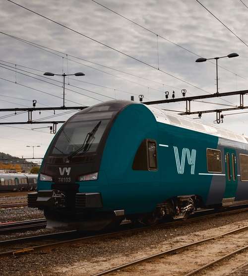 Vy train with people in the foreground.