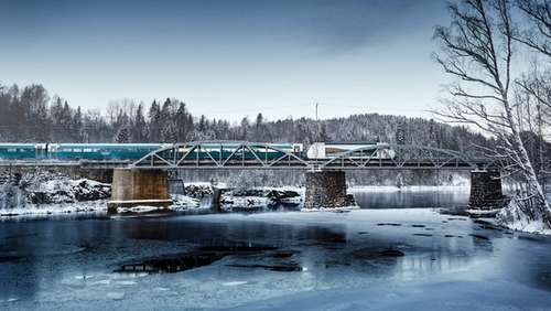 Train on a bridge over icy water.
