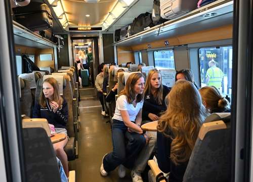 Young people on the train sitting together and talking