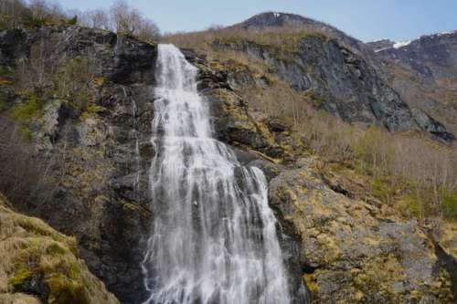 A waterfall rushing down a mountain side.