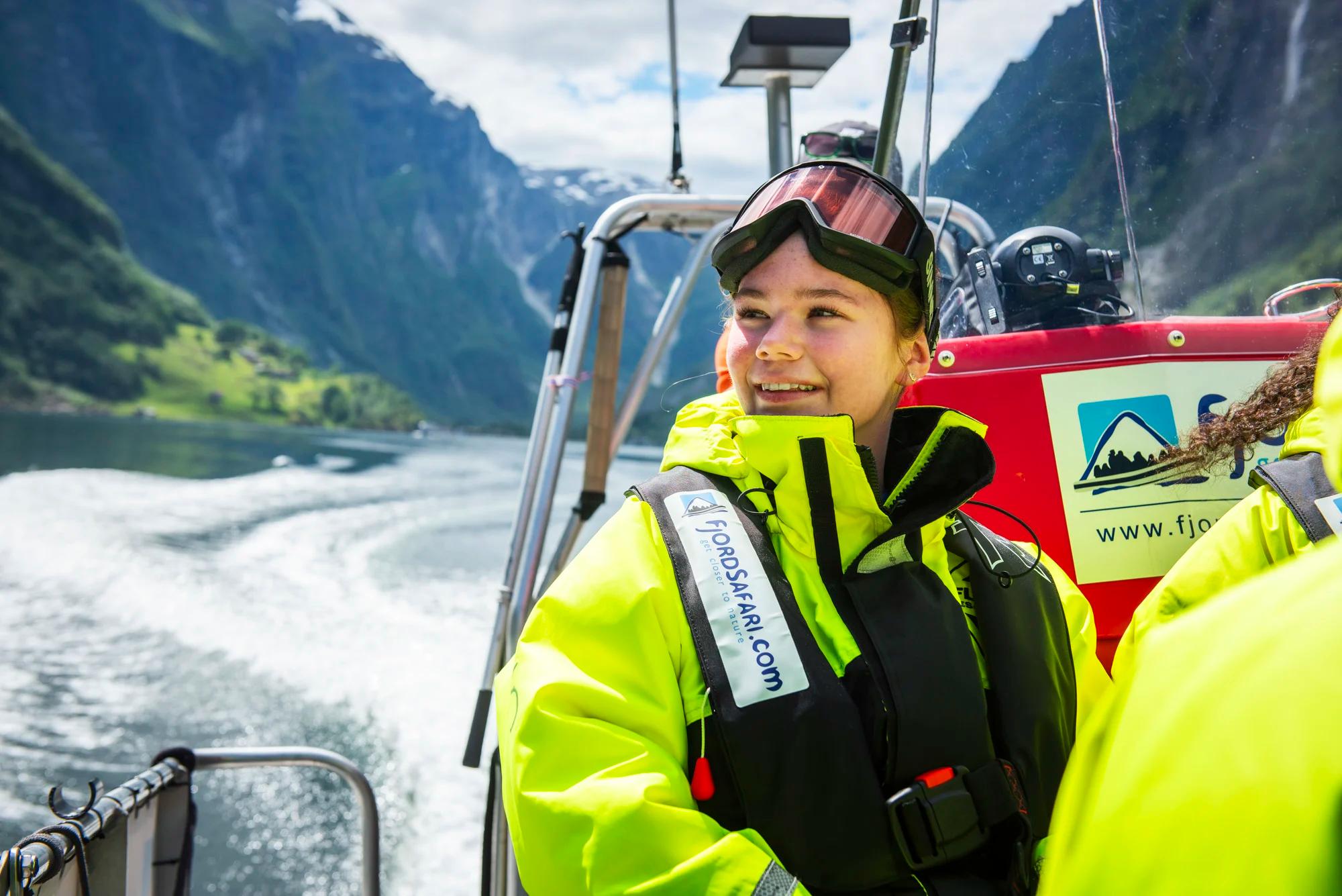 Girl sitting in a RIB boat on the fjord