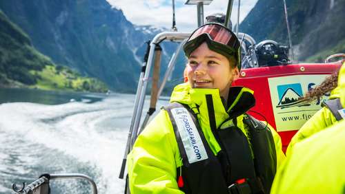 Girl sitting in a RIB boat on the fjord