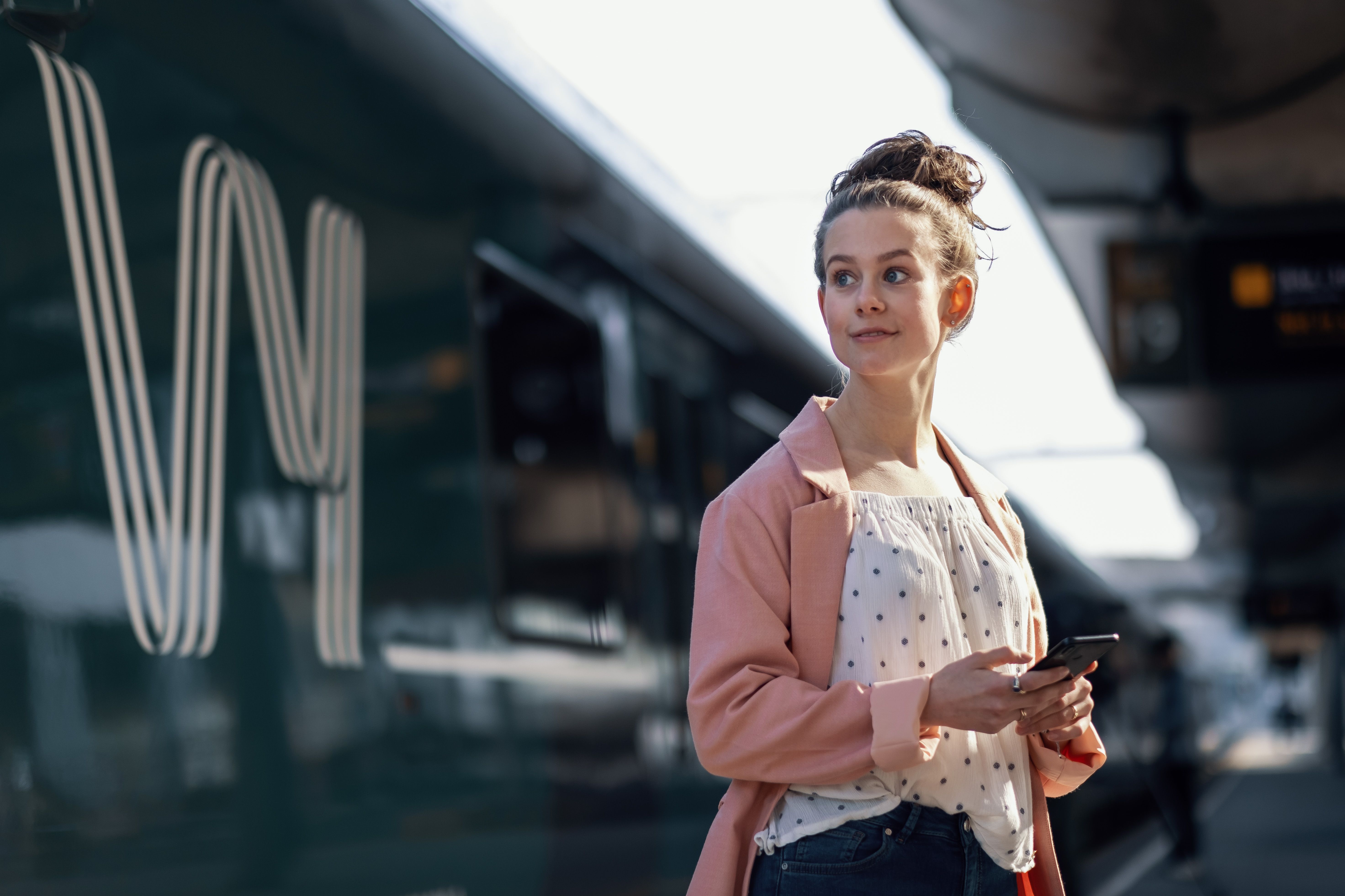 Young woman looking at a train
