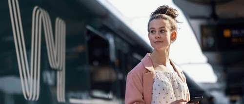 Young woman looking at a train