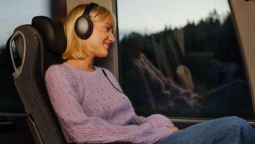 Satisfied young woman sitting in a bus seat.
