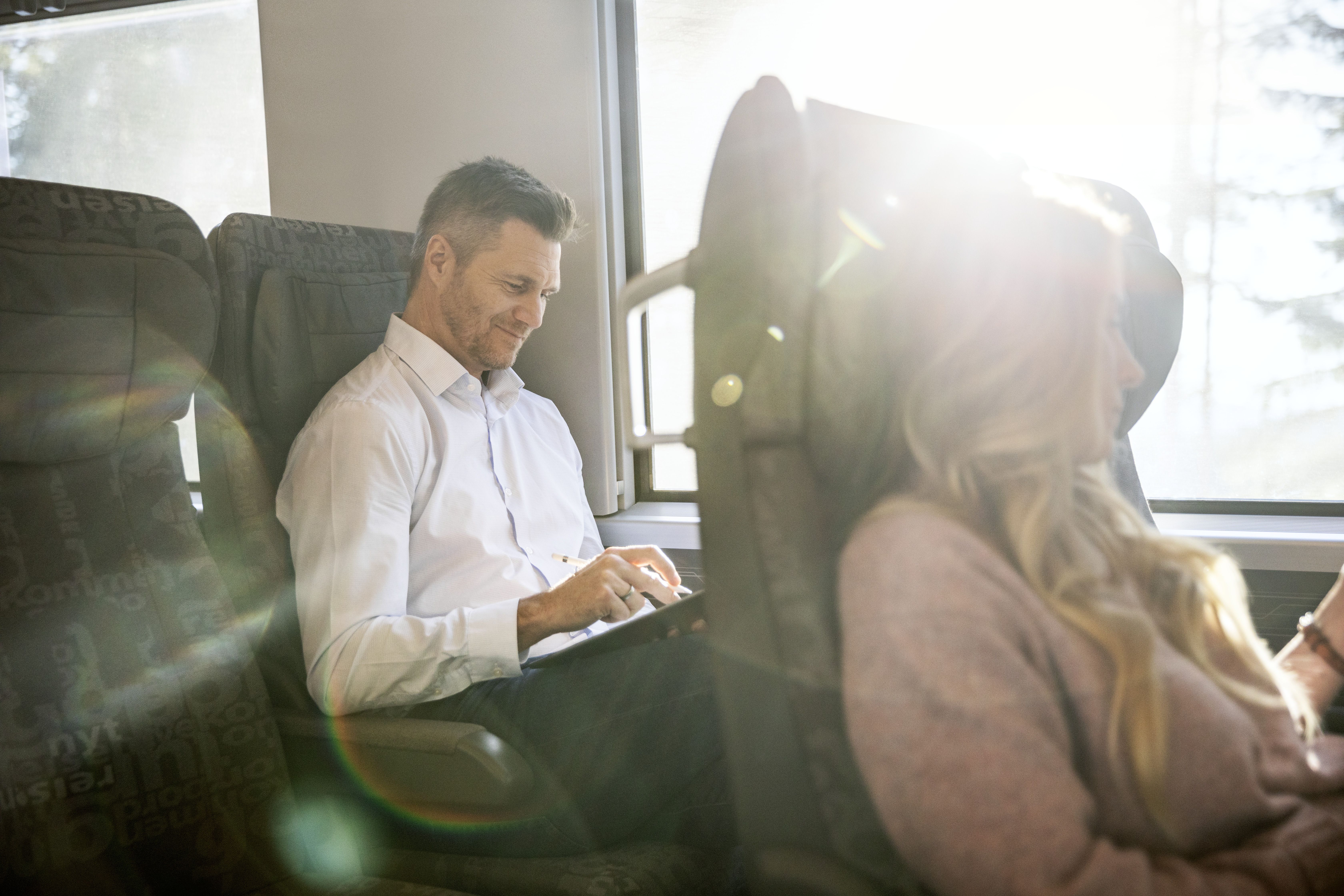 Men and woman sitting on the train