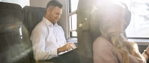 Men and woman sitting on the train